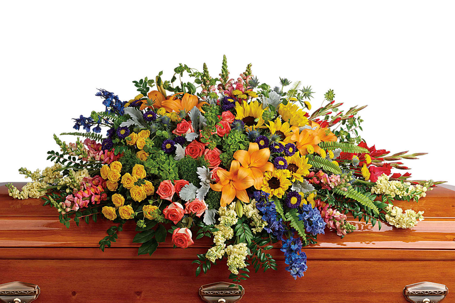 a casket spray with very colorful flowers, red, yellor and pink roses,  sunflowers, ferns, lilies and a bunch of other flowers in this beautiful funeral flower arrangement