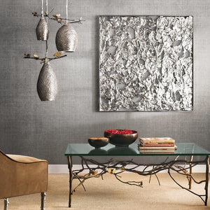 A stunning metal wall decor in a reading room, three metal light fixtures are hanging from the ceiling, and the sunlight is coming through a window on the right.