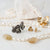 Jewelry pieces on a white surface, and a white crystal on the background.