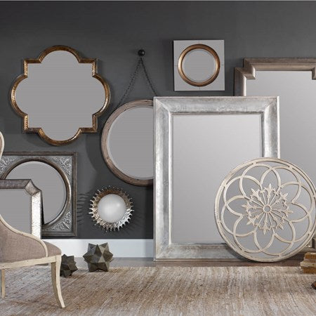 A collection of mirrors, all of them on different sizes, shapes and finish.
