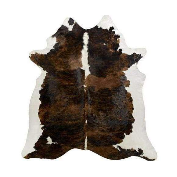 A Cowhide Rug in a Dark Tricolor Pattern, including, white and dark brown and black