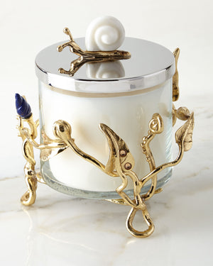 A beautiful aromatic candle set on a cage made of metallic golden branches, and a golden snail on the lid