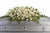 A stunning testament funeral arrangement in white, this spray for the casket includes roses, orchids, calla lilies and hydrangea accented by soft, trailing greens.