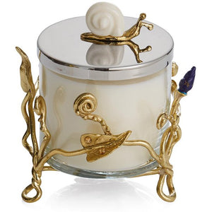 A beautiful aromatic candle set on a cage made of metallic golden branches, and a golden snail on the lid