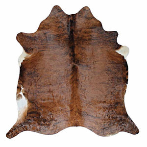 A Cowhide Rug in a Dark Brindle pattern, with brown and whites shapes