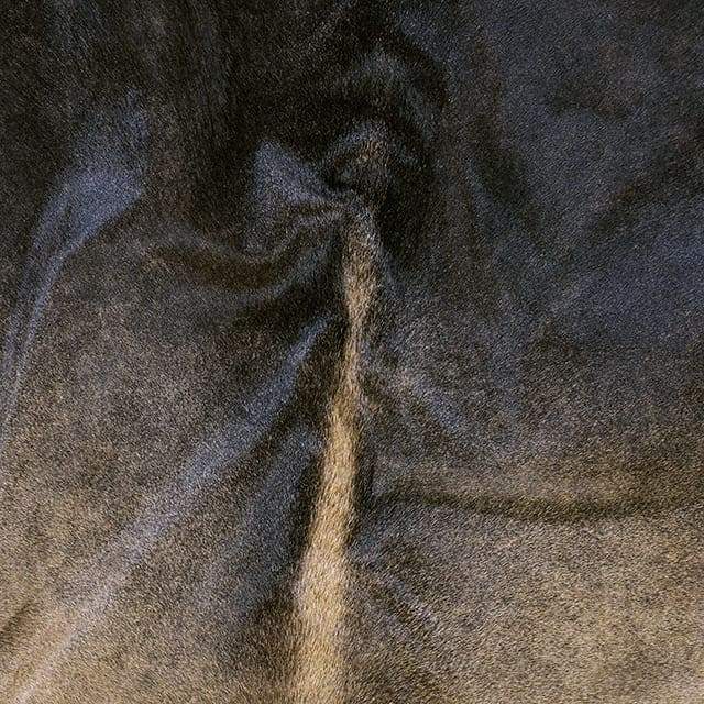 A Cowhide Rug in a Dark brown color