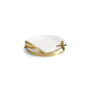 A white catch all, with a golden ring at the bottom, and a very delicate golden branch and a leaves around it