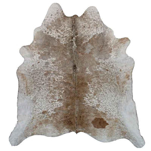 A Cowhide Rug in a Tan & White Natural Color