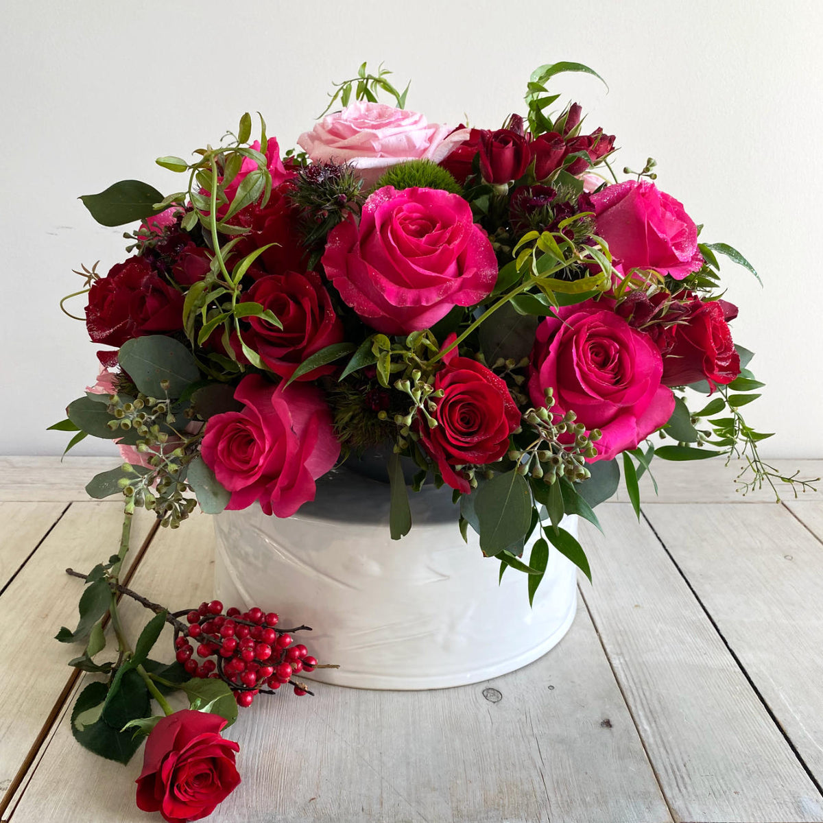 A Jaw-dropping floral design that showcases the pure beauty of a rose. A stunning arrangement of paved mixed roses and greens. Featuring red hearts roses. Pink Floyd Roses and romantic O&#39;Hara garden roses. Topped with a touch of glitter.